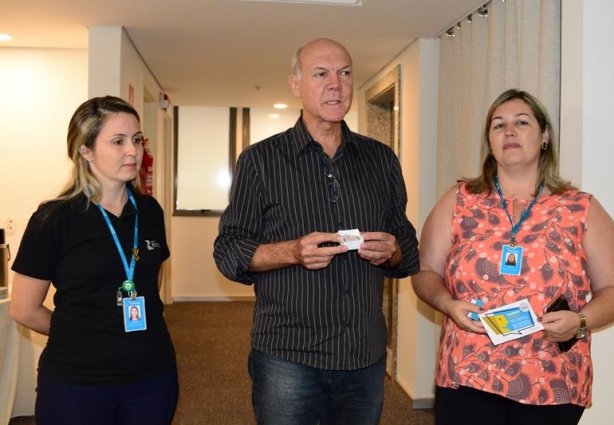 Eduardo Mantovani ao receber a miniatura da Comenda, ladeado pelas jornalistas Josiane Campos (esq.) e Luciana Nascimento (dir.)